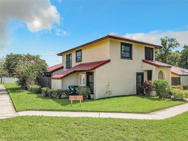 mediterranean / spanish-style home with a front yard