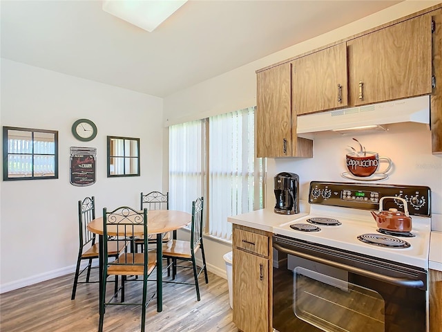 kitchen with range with electric stovetop and light wood-type flooring