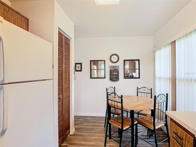 dining space featuring dark hardwood / wood-style floors