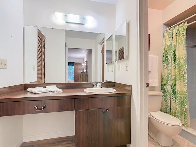 bathroom with toilet, vanity, and a shower with shower curtain