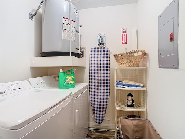 washroom with electric water heater, electric panel, and washing machine and clothes dryer