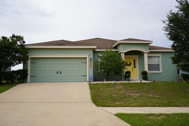 view of front of house with a front yard and a garage