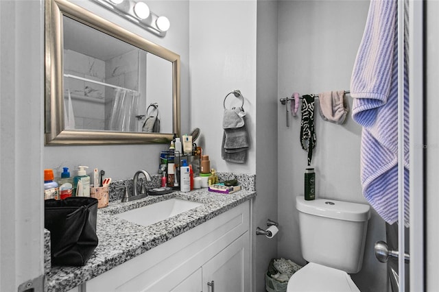 bathroom with vanity, toilet, and a shower with curtain