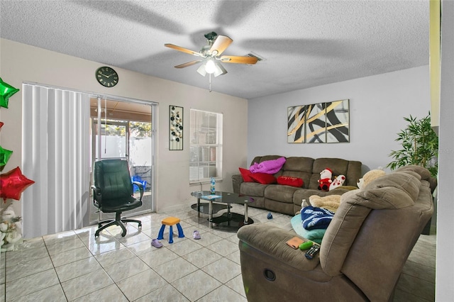 tiled living room with ceiling fan and a textured ceiling