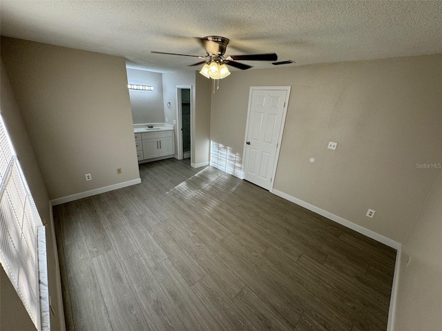 unfurnished room with ceiling fan, a textured ceiling, light hardwood / wood-style flooring, and a healthy amount of sunlight