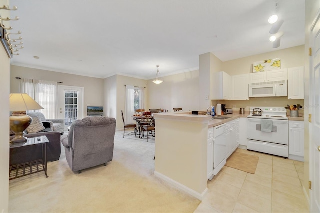 kitchen with white appliances, decorative light fixtures, white cabinetry, light carpet, and kitchen peninsula