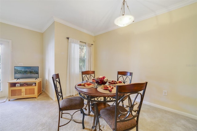 dining room featuring ornamental molding and light carpet