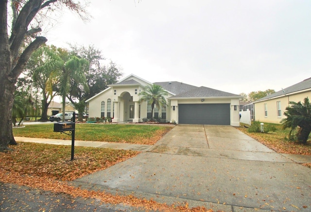 view of front of house featuring a garage and a front yard