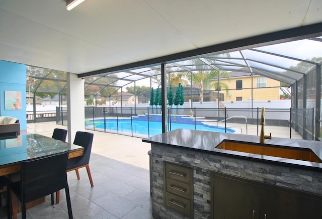 view of pool featuring an outdoor bar, a lanai, and a patio