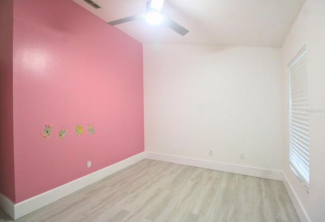 spare room featuring light wood-type flooring and ceiling fan