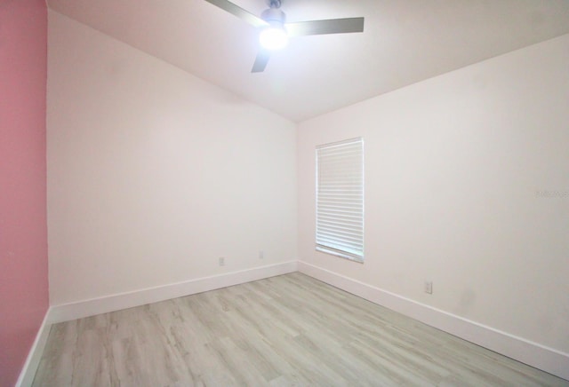 empty room featuring ceiling fan, light hardwood / wood-style floors, and lofted ceiling