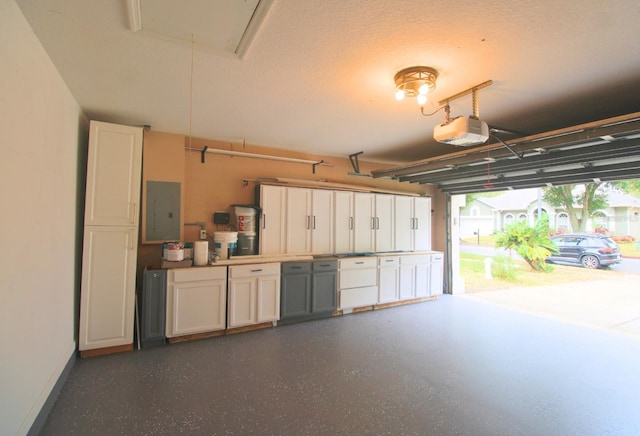 garage with electric panel and a garage door opener