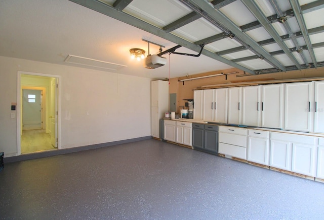 garage featuring electric panel and a garage door opener