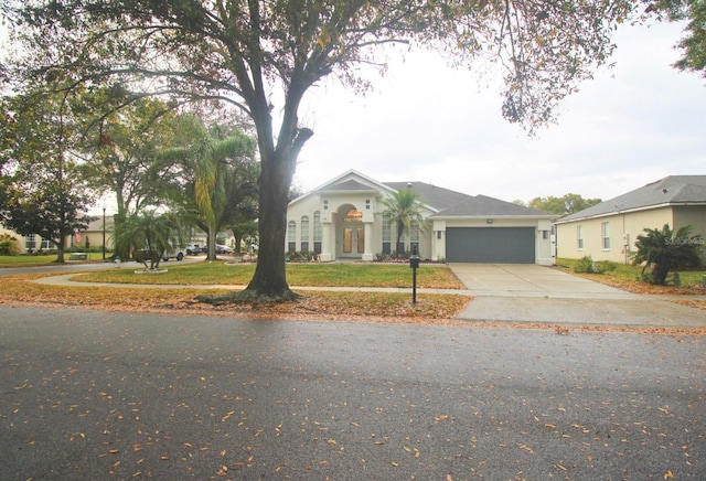 ranch-style home with a garage and a front yard