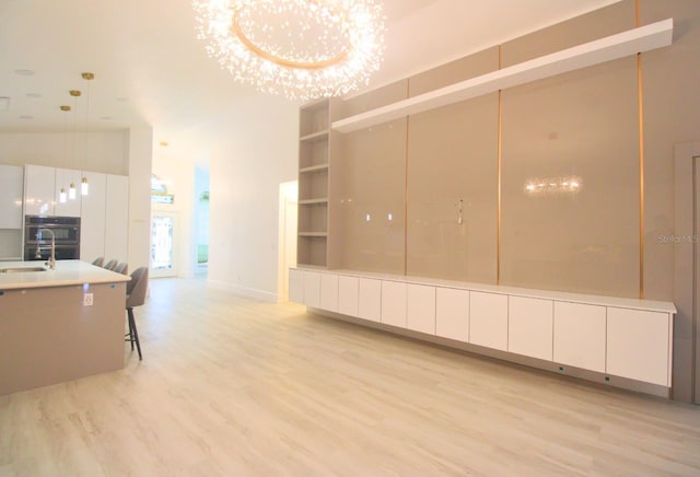 interior space featuring sink and light hardwood / wood-style floors