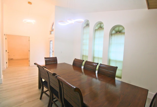 dining space with light wood finished floors and built in features