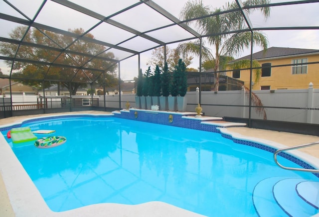 view of swimming pool with a lanai and a patio