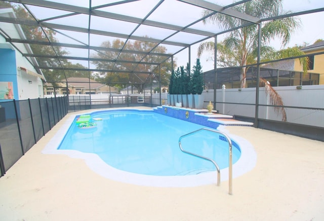 view of swimming pool featuring glass enclosure and a patio area