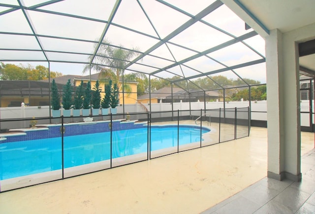 view of swimming pool with a fenced in pool, a patio area, glass enclosure, and a fenced backyard