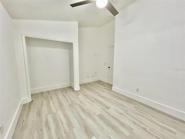 unfurnished bedroom with baseboards, ceiling fan, and light wood finished floors