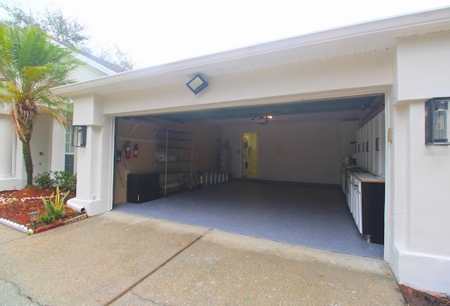 garage with water heater and concrete driveway