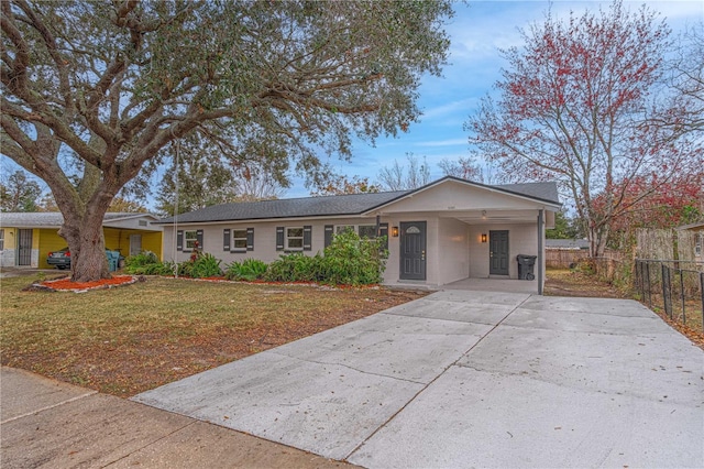 ranch-style house with a front yard and a carport