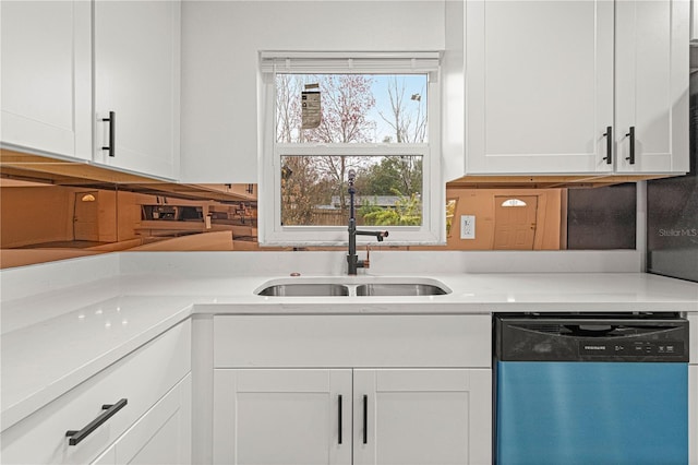 kitchen featuring dishwasher, sink, and white cabinetry