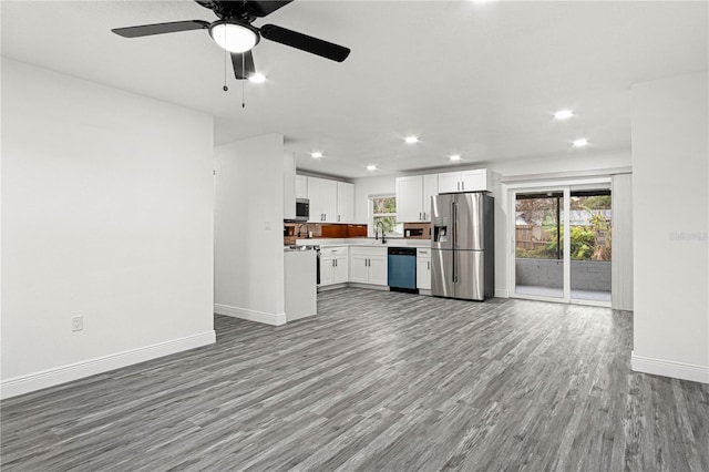 kitchen featuring appliances with stainless steel finishes, plenty of natural light, white cabinetry, and light hardwood / wood-style flooring