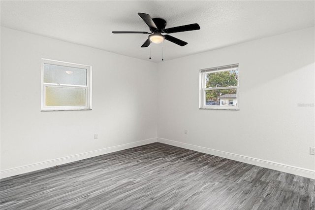 unfurnished room featuring ceiling fan and dark wood-type flooring