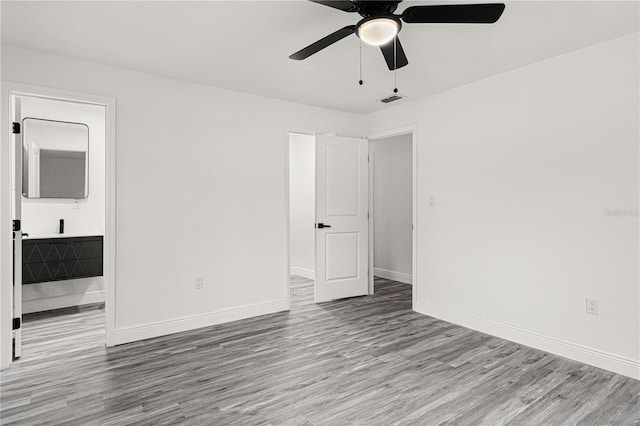 empty room with ceiling fan and light wood-type flooring