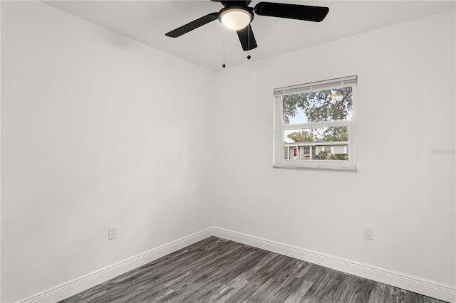 spare room with ceiling fan and dark hardwood / wood-style flooring