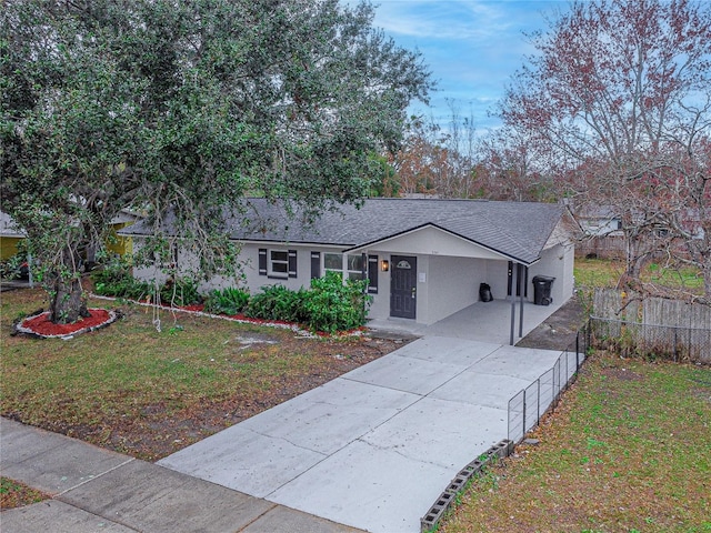 ranch-style house with a front yard and a carport