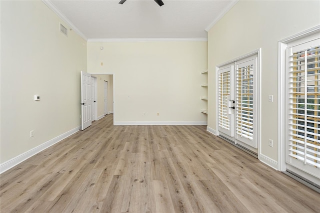 spare room with crown molding, built in features, light hardwood / wood-style floors, and ceiling fan