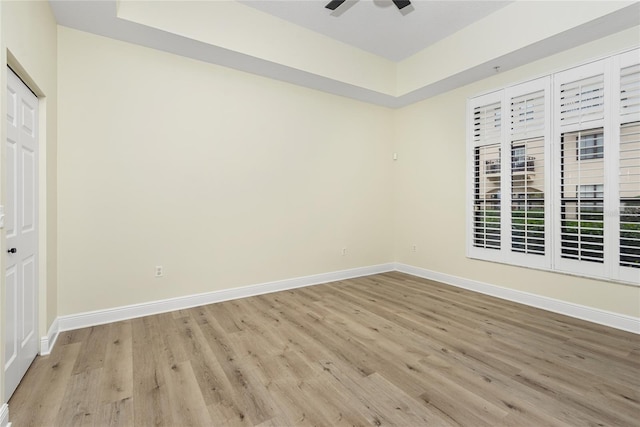 unfurnished bedroom featuring ceiling fan, light hardwood / wood-style floors, and a closet