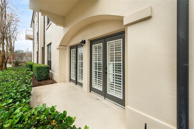 doorway to property with a patio area and french doors