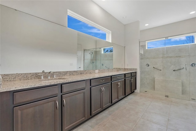 bathroom with vanity, a shower with door, and tile patterned flooring