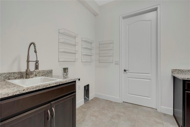 washroom with cabinets, electric dryer hookup, sink, hookup for a washing machine, and light tile patterned floors