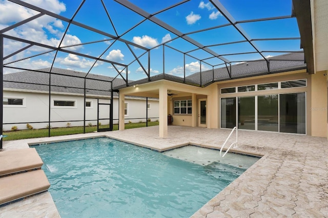 view of pool with a jacuzzi, a lanai, and a patio area