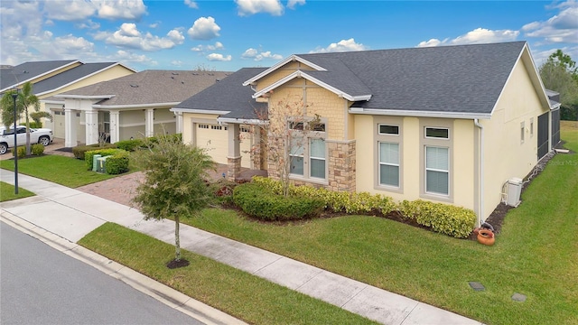 view of front of house with a garage and a front lawn