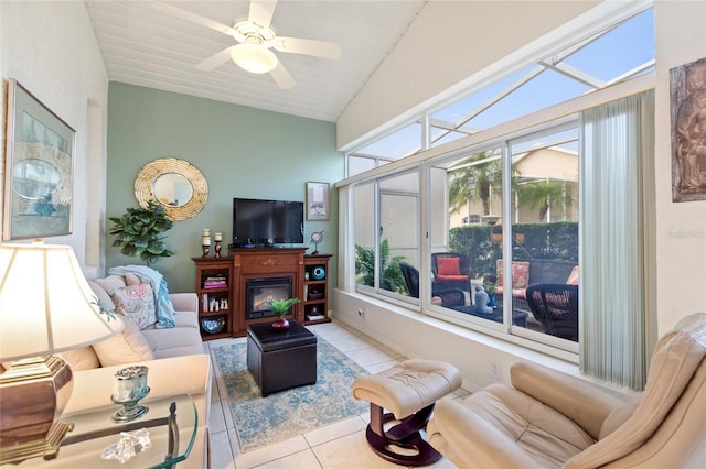 tiled living room featuring vaulted ceiling and ceiling fan