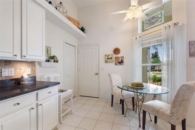 tiled dining room featuring ceiling fan