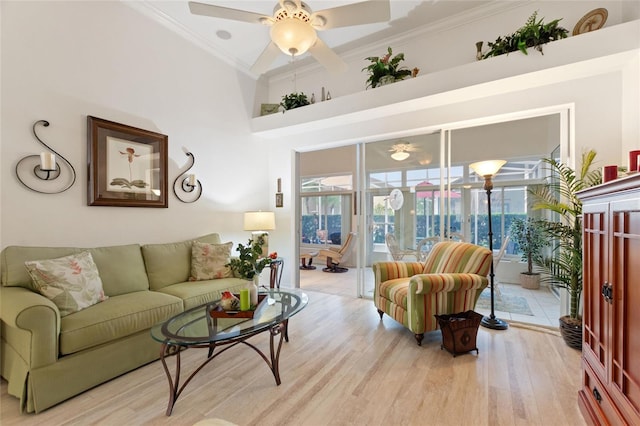 living room with crown molding, ceiling fan, and light hardwood / wood-style flooring