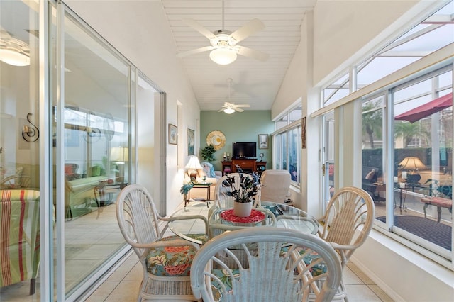 sunroom featuring vaulted ceiling, wooden ceiling, and ceiling fan