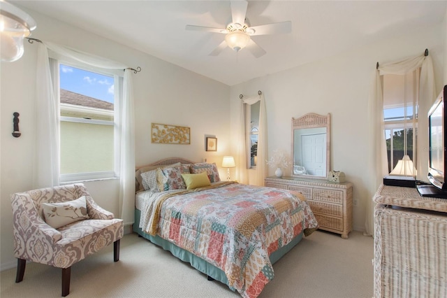 bedroom with ceiling fan and light carpet