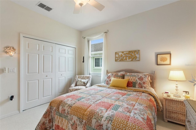 carpeted bedroom featuring ceiling fan and a closet