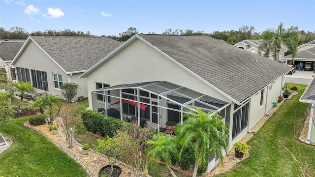 back of property with a yard and a lanai