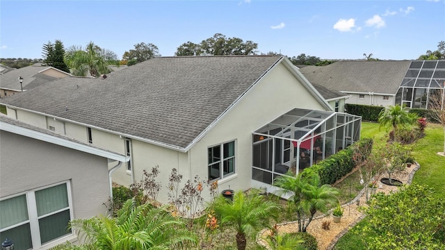 rear view of property with glass enclosure