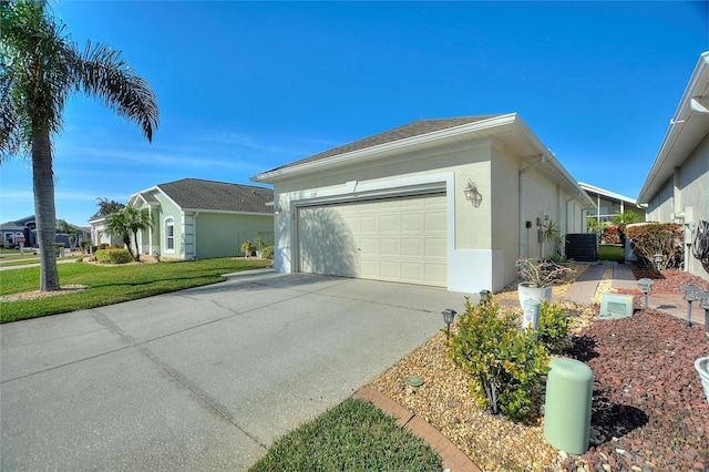 view of home's exterior with cooling unit, a garage, and a yard