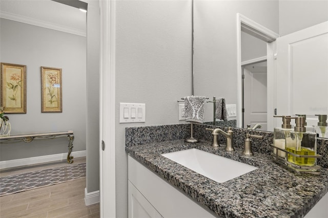 bathroom featuring ornamental molding and vanity