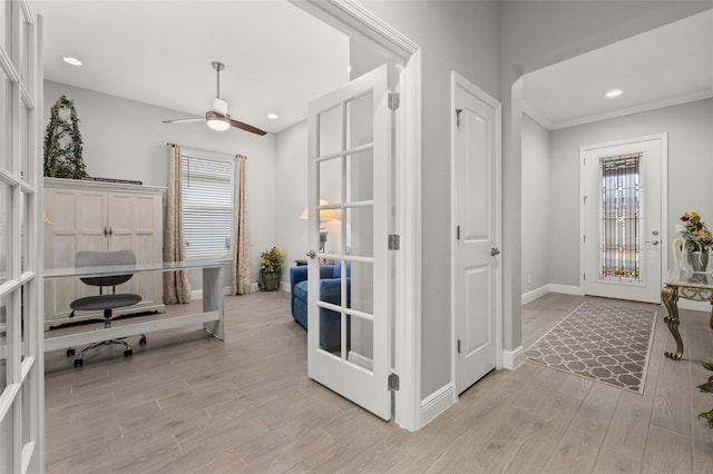 home office featuring french doors, ceiling fan, and light hardwood / wood-style flooring